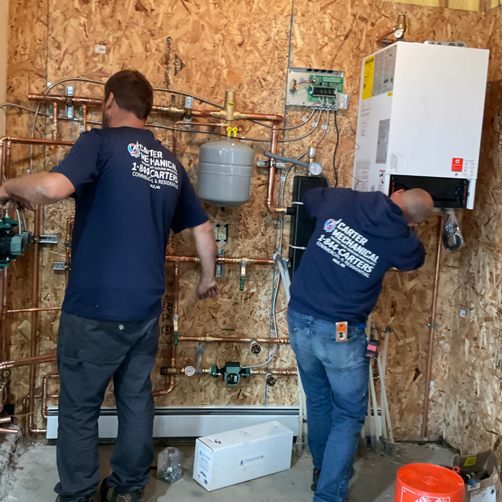 Carter Mechanical Heating and Cooling  Working on a boiler